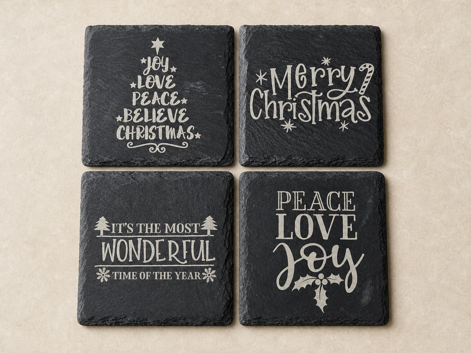 Four black slate coasters engraved with coordinating Christmas messages